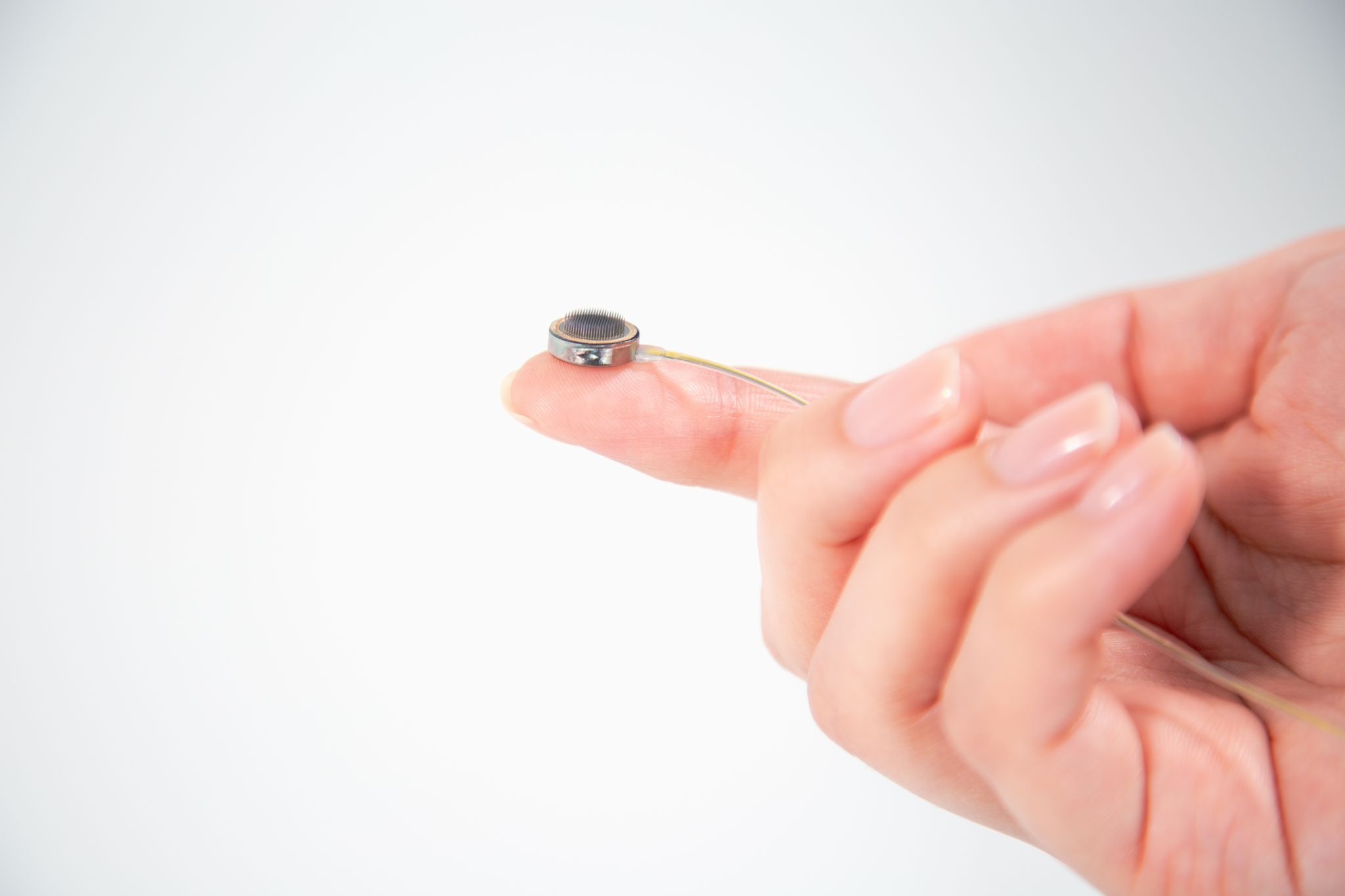 Paradromics&rsquo; Connexus BCI cortical module held on fingertip